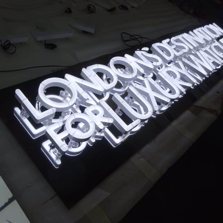 Mirrored faux neon sign with box illuminated letters. Menswear and fashion signmaking from NeonPlus