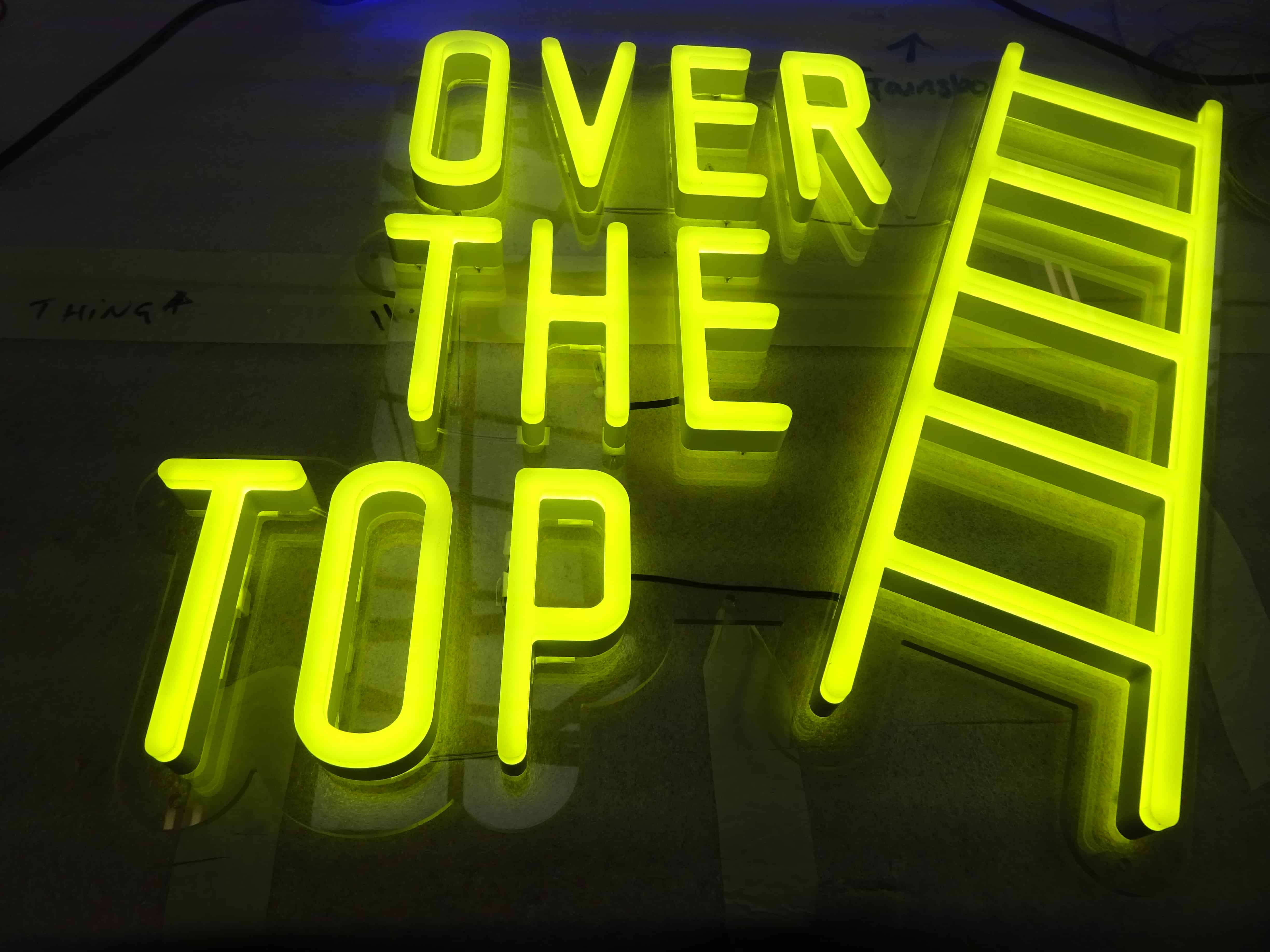 Yellow ladder neon sign alternative with eco-friendly LED lighting and illuminated text.