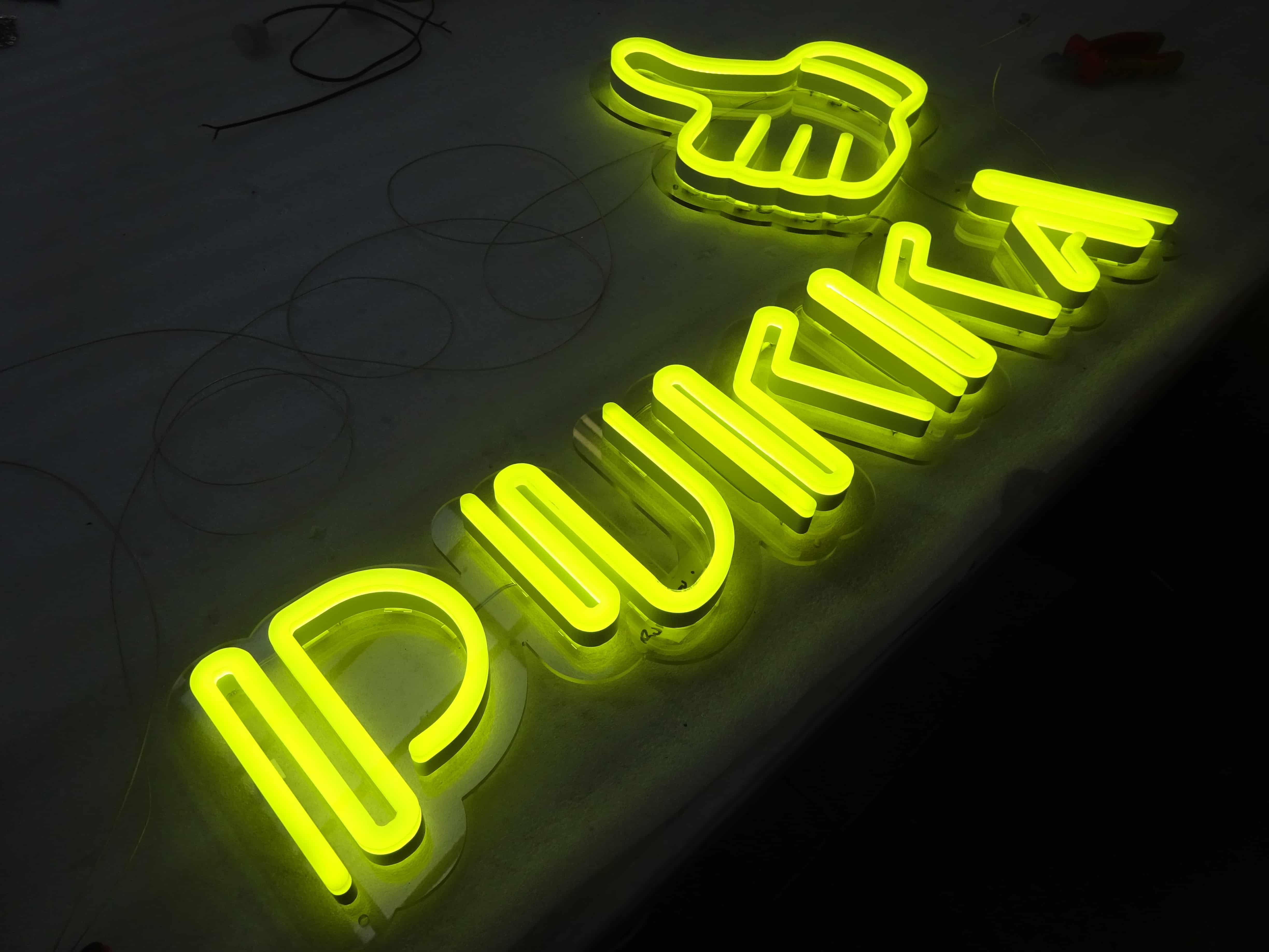 Thumbs up and illuminated writing faux neon sign reading 'Pukka' custom made by NeonPlus
