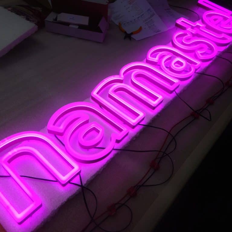 Pink border illuminated neon alternative sign. Custom faux neon sign reading 'Namaste' from Neonplus