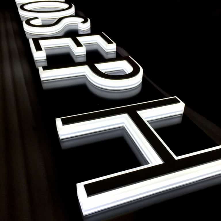 Joseph logo in block capitals, white and black, fixed to a black sign tray