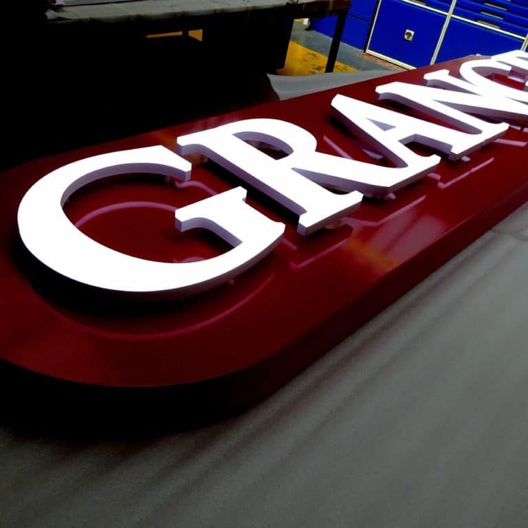 Grange logo white LED lettering in Neon Plus, fixed to a red aluminium sign tray