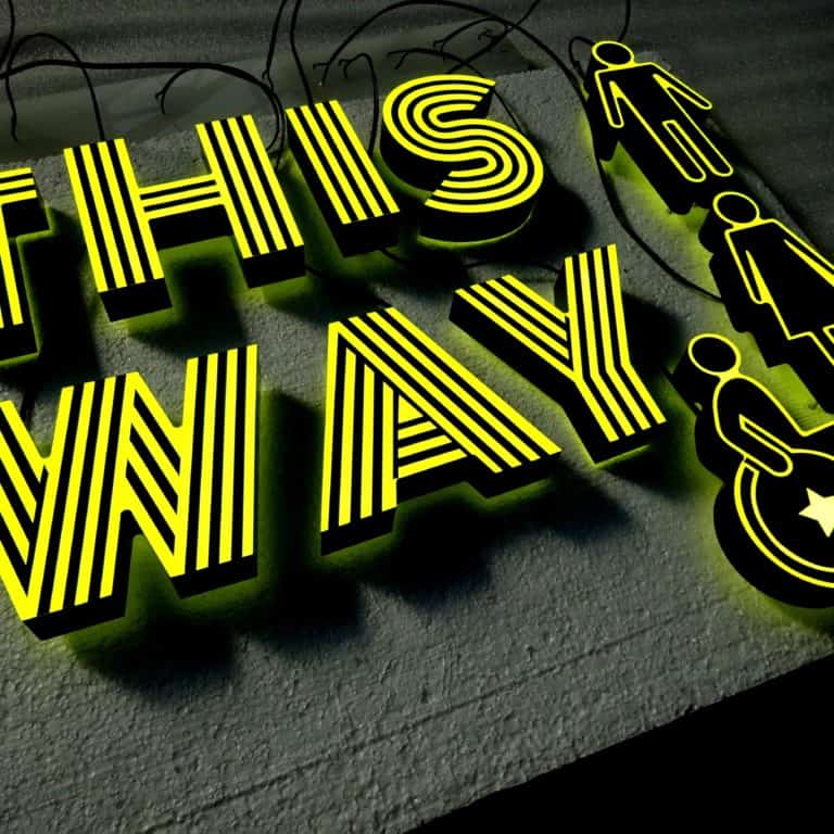 Yellow 'this way' lettering with striped pattern and mens, ladies and disabled toilet symbols - NeonPlus super-bright neon signs