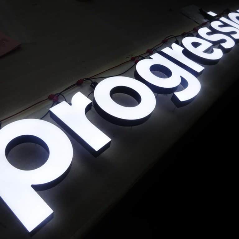 Face-lit white text reading 'Progression' illuminated with faux neon alternatives for crisp brand-friendly signs, made by Neonplus