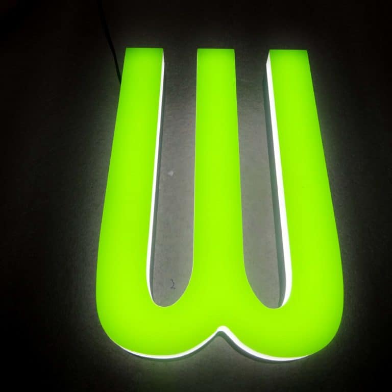 Face illuminated green capital letter sign, with white back-lighting. Eco-friendly neon sign alternatives made by NeonPlus