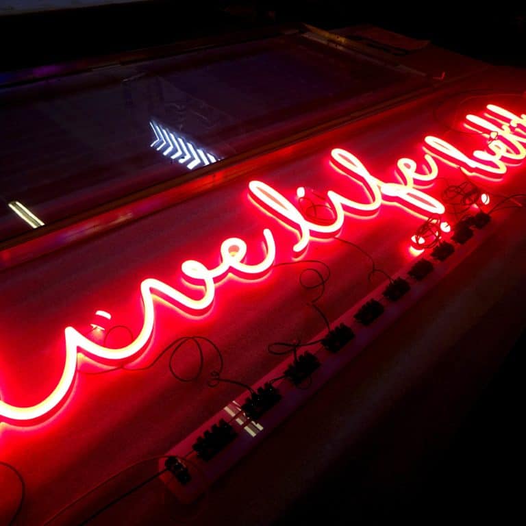 Faux neon signs with red handwriting. 'Live life better' Neonplus sign for sign making.