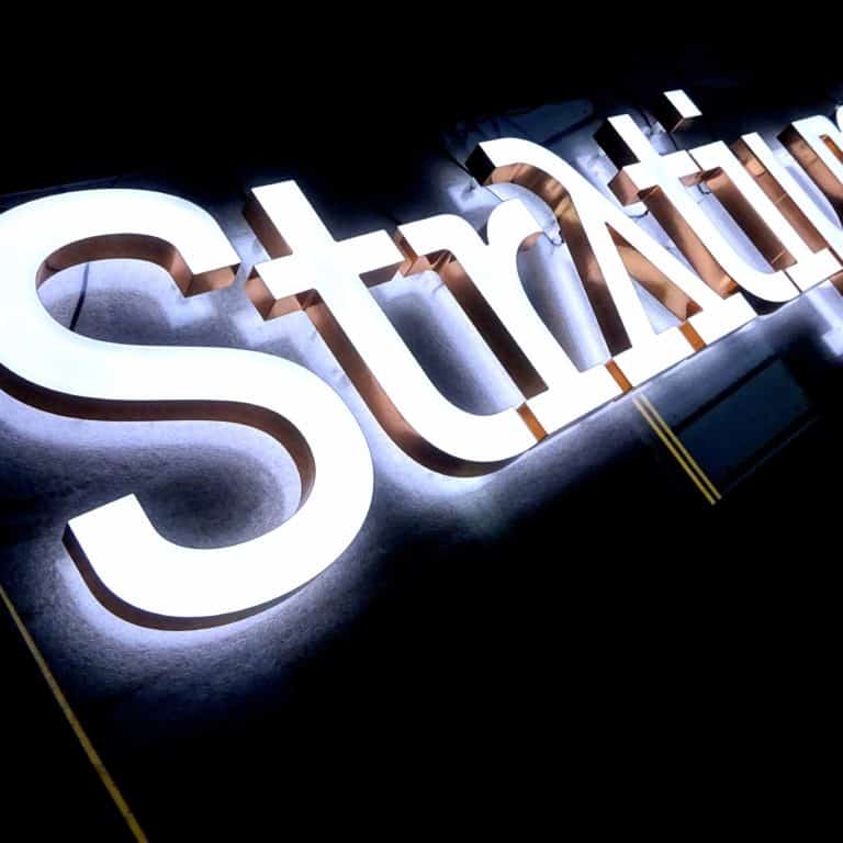 White neon logo signs for businesses and storefronts. Artificial neon from Neonplus