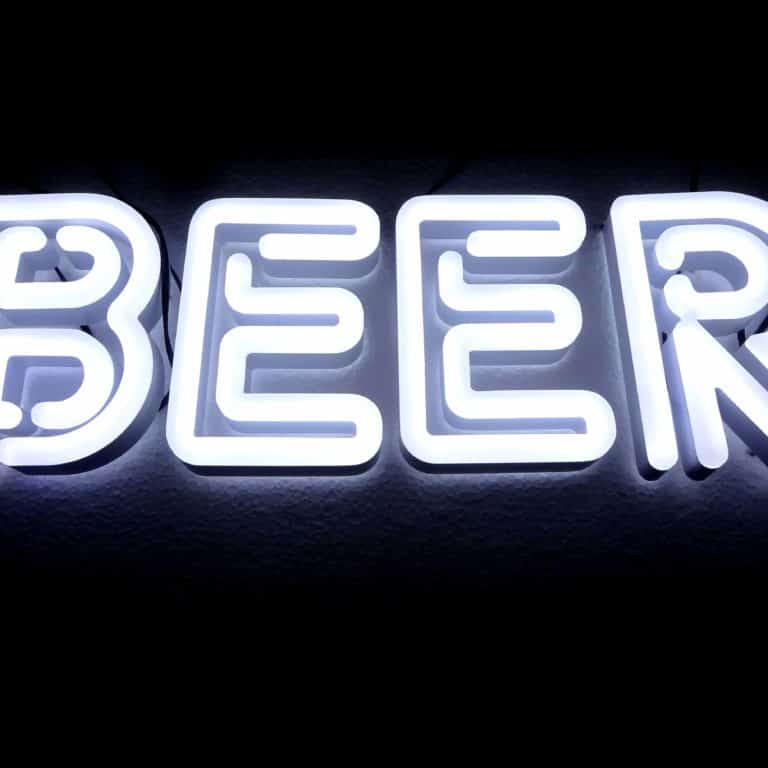 Neon bar sign with white capitals writing. Alternative neon signs for bars, shops, and business logos.