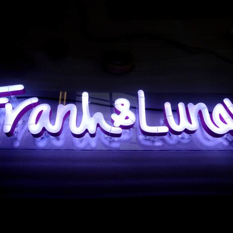 Frank & Luna's neon sign made in white cursive neon alternatives from Neonplus. Weatherproof business signs for outdoor use from Neonplus.