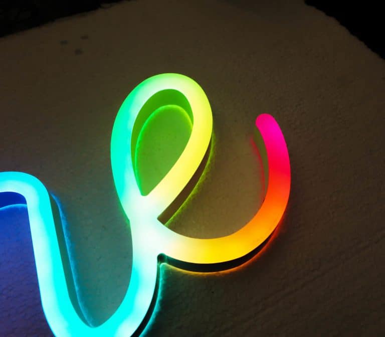 Colour changing digital neon style signs with programmeable displays. Neonplus faux neon handwriting signs.