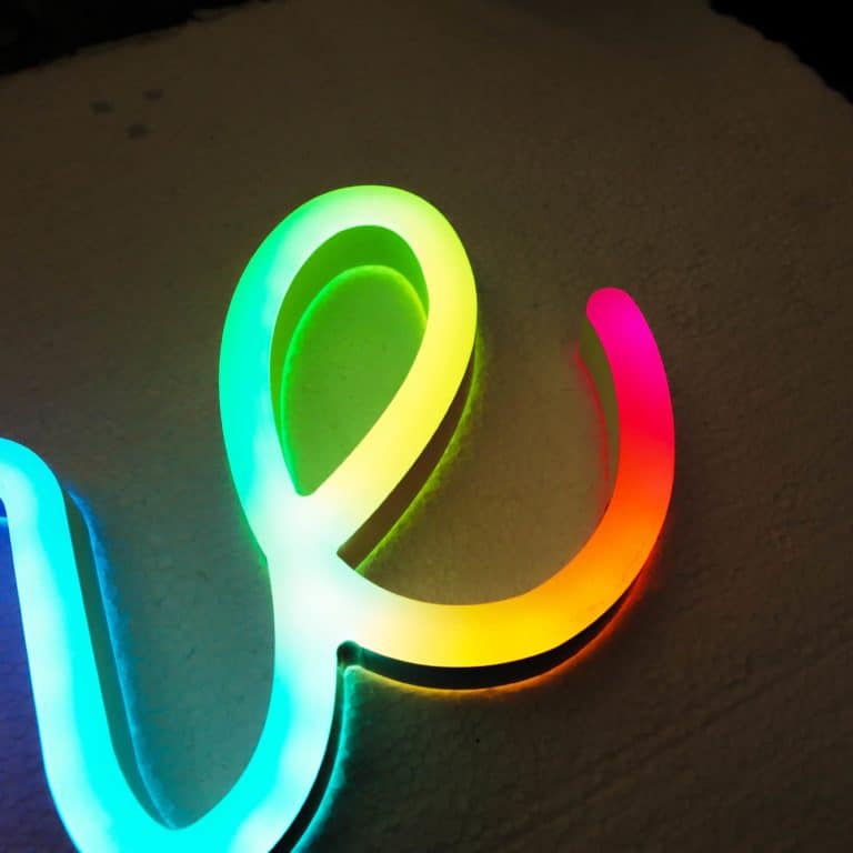 Colour changing digital neon style signs with programmeable displays. Neonplus faux neon handwriting signs.